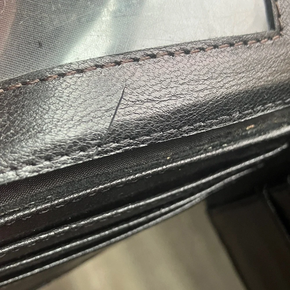 black bifold wallet made from genuine ostrich leather.